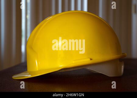 Casque de sécurité jaune sur la table.Vue latérale du casque de sécurité jaune. Banque D'Images