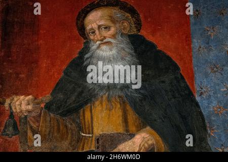 Saint Anthony ou Antony le Grand, connu sous le nom de «Père de tous les Monks». Fresque Renaissance dans l'ancienne Chiesa dei Santi Giovanni e Reparata (église des Saints Jean et Reparata) à Lucca, Toscane, Italie. Le saint, également connu sous le nom d'Anthony l'Abbé, était un ermite chrétien précoce d'Égypte qui serait mort en 356 après J.-C., âgé de 105 ans. Ici, il est représenté en tenant la poignée en T d'une équipe en bois ou d'une béquille portant une cloche suspendue. Banque D'Images