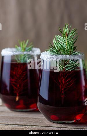 Boisson rouge canneberge décorée de branches de sapin, de baies et de ...