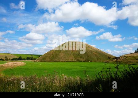 Silbury Hill près d'Avebury Préhistorique Nolithic artificielle de craie monolithe en été bleu ciel blanc nuages vert herbe en premier plan Banque D'Images