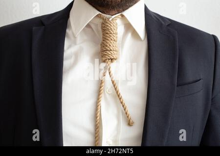 homme en costume sombre portant une corde avec le pendu nez, comme une cravate Banque D'Images