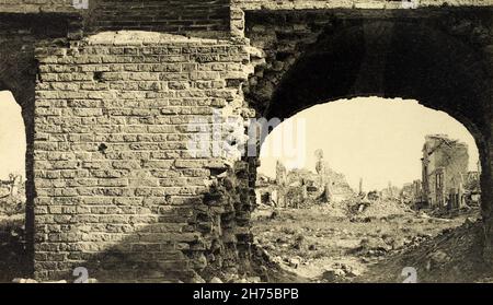 Une vue historique de la ville dévotée de Nieuwport, en Belgique, peu après la première Guerre mondiale.Les ruines de la place du marché de la ville sont vues à travers le mur de la salle de tissu.Tiré d'une carte postale c. début des années 1920. Banque D'Images