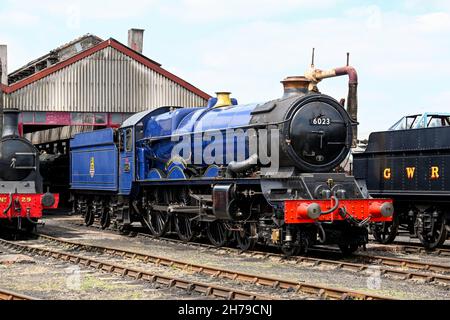 Didcot, Angleterre - juin 2021 : moteur à vapeur d'époque à l'extérieur d'un hangar à moteur à côté d'autres locomotives Banque D'Images