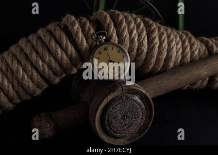 Une vieille montre de poche sur un fond en bois décoré de ficelle Banque D'Images