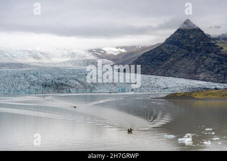 Vue panoramique sur la lagune glaciaire avec le terminus ou la fin du glacier de Jokulsarlon, en Islande avec un nombre de zodiacs dans l'eau Banque D'Images