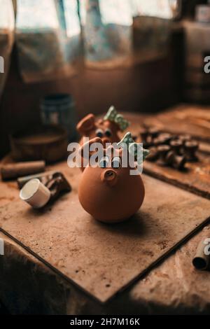 Potier faisant la décoration d'argile à l'établi en poterie Banque D'Images