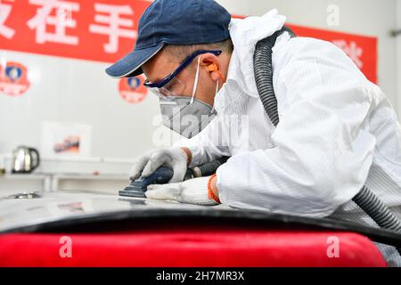 Longli, province chinoise du Guizhou.23 novembre 2021.Un concurrent participe au concours de peinture automobile lors d'un concours de compétences professionnelles dans le comté de Longli, dans la province de Guizhou, dans le sud-ouest de la Chine, le 23 novembre 2021.Credit: Yang Wenbin/Xinhua/Alamy Live News Banque D'Images