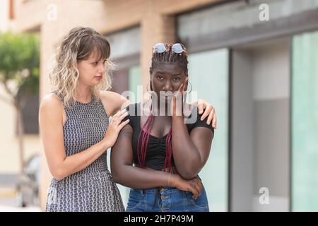 Jeune femme consolant et réconfortant à son ami contrarié Banque D'Images