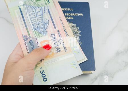 Traduction: Mercosur, République fédérative du Brésil, Passeport et pesos uruguayens, concept de voyage pandémique. Banque D'Images
