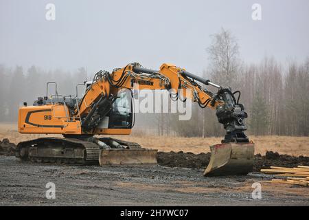 Pelle sur chenilles Liebherr 918 sur le chantier, le printemps est brumeux.Forssa, Finlande.2 avril 2017. Banque D'Images