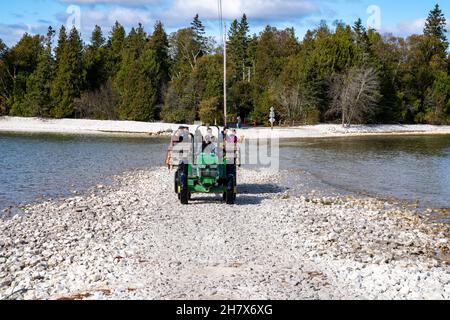 Door County, Wisconsin - le 22 octobre 2021 : les touristes vont faire un tour en voiture à travers un brise-lames inondé dans le lac Michigan pour visiter Cana Island Lightho Banque D'Images