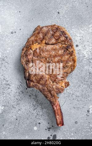 Steak de bœuf grillé Tomahawk, entrecôte.Arrière-plan gris.Vue de dessus Banque D'Images