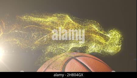 Image de particules d'or brillantes se déplaçant au-dessus du basket-ball Banque D'Images