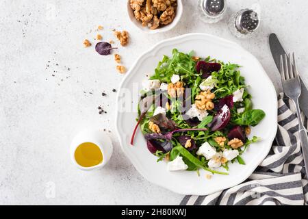 Salade de betteraves saines avec noix et fromage de chèvre sur plaque garnie de vinaigrette à l'huile d'olive, vue du dessus espace pour les copies Banque D'Images
