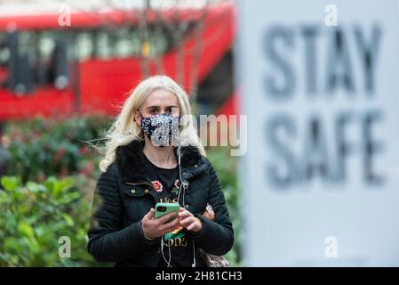 Londres, Royaume-Uni.26 novembre 2021.Une femme portant un masque de façade lors du Black Friday à Oxford Street, alors qu'une nouvelle souche de Covid-19 originaire d'Afrique du Sud a été détectée en Europe.Ce qui a rapporté que les offres du Vendredi fou ne sont pas toutes ce qu'ils semblent avec des articles offerts moins cher à d'autres périodes de l'année.En outre, en raison des problèmes d'approvisionnement causés par la pandémie et le Brexit, certains détaillants ont du mal à offrir des réductions.Credit: Stephen Chung / Alamy Live News Banque D'Images