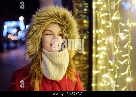 Adorable jeune fille s'amuser à Vilnius, Lituanie.Enfant admirant les lumières de Noël.L'hiver en famille et avec les enfants. Banque D'Images