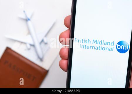 Logo de l'application British Midland International Airlines sur l'écran du téléphone portable.Image floue d'un avion, d'un passeport et d'une carte d'embarquement en arrière-plan.Novembre 2021, San Francisco, États-Unis Banque D'Images