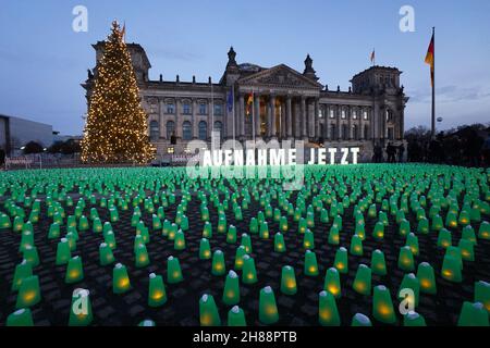 Berlin, Allemagne.28 novembre 2021.Une mer de lumières vertes et le lettrage 'Aufnahme Jetzt' peuvent être vus en face du Reichstag lors d'une action par les organisations Seebrücke, Campact et d'autres pour l'admission des réfugiés de la frontière biélorusse-polonaise.Credit: Jörg Carstensen/dpa/Alay Live News Banque D'Images