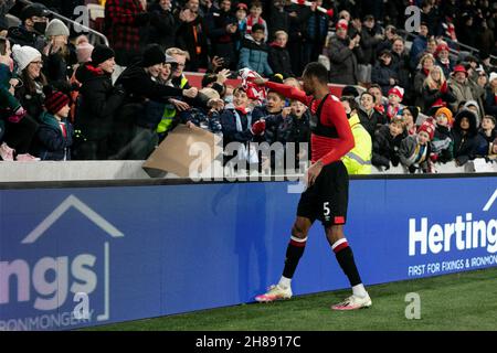 LONDRES, GBR.28 NOV Ethan Pinnock de Brentford donne son maillot à un fan après le match de la Premier League entre Brentford et Everton au stade communautaire de Brentford, Brentford, le dimanche 28 novembre 2021.(Crédit : Juan Gasparini | ACTUALITÉS MI) crédit : ACTUALITÉS MI et sport /Actualités Alay Live Banque D'Images