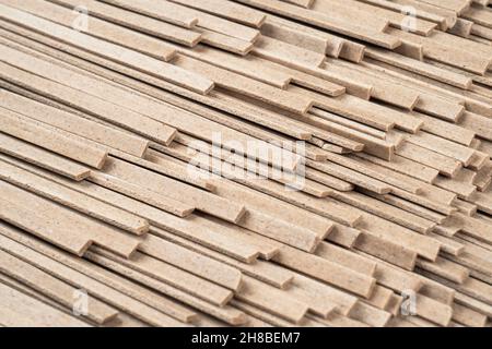 Fond de texture de nouilles soba non cuites.Motif de surface des nouilles.Nouilles de sarrasin crues.Fond de plan de la nourriture de macro. Banque D'Images