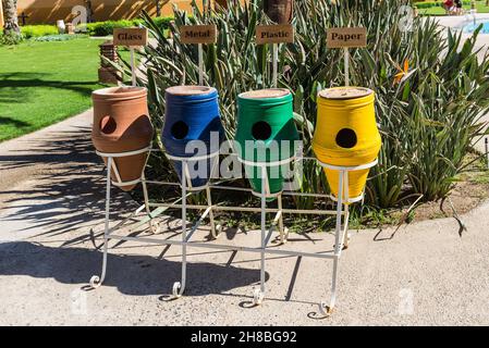 Hurghada, Égypte - 24 mai 2021 : des pots de poubelle en argile colorée trient les déchets pour le verre, le papier, le métal et le plastique dans la baie de Makadi, que l'un des Égyptiens a de plus Banque D'Images