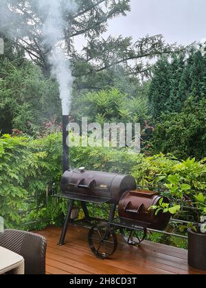 Fumeur barbecue fumeur sur une terrasse, Allemagne Banque D'Images