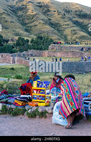 Vendeurs locaux vendant des souvenirs sur les ruines de la forteresse Puka Pukara Inca Banque D'Images