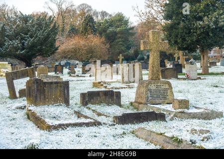 Vue sur le cimetière de l'église St Michael's à Tilehurst Reading en hiver avec une couverture de neige légère. Banque D'Images