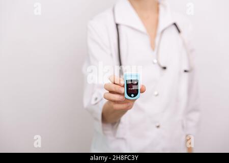 Oxymètre de pouls avec main du médecin isolé sur blanc.Le concept de dispositif numérique portable pour mesurer la saturation en oxygène de la personne.Mesure de l'oxygène Banque D'Images