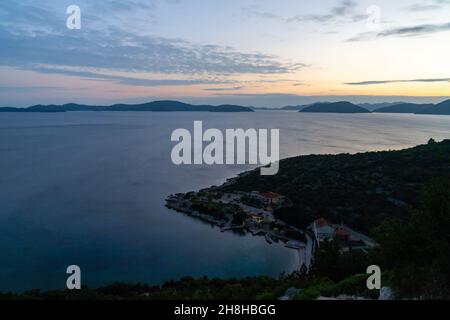 Coucher de soleil coloré sur l'autoroute Adriatique en Croatie avec vue sur la côte et silhouettes des îles au loin Banque D'Images