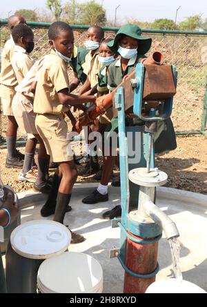 Gwanda, province de Matabeleland-Sud du Zimbabwe.3 novembre 2021.Les élèves peuvent aller chercher de l'eau dans un puits de forage d'une école primaire de Gwanda, province du Sud de Matabeleland, Zimbabwe, 3 novembre 2021.Les projets de forage de trous de sonde financés par la Chine fournissent une bouée de sauvetage aux communautés pauvres en eau en Afrique où l'accès facile à l'eau potable reste un défi pour certaines populations du continent.POUR ALLER AVEC 'Feature: Les projets d'eau soutenus par la Chine apportent de la joie aux communautés en Afrique' Credit: Chen Yaqin/Xinhua/Alamy Live News Banque D'Images