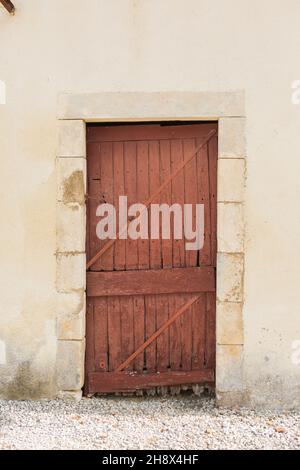 Ancienne porte en bois dans une grange appartenant à un château français dans la région de la Loire en France Banque D'Images