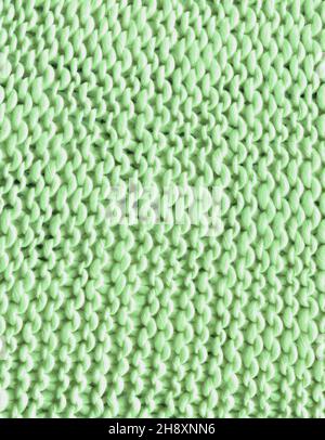Fond en laine de tricot kaki vert chaud.De magnifiques textiles en laine tricotée comme arrière-plan. Banque D'Images