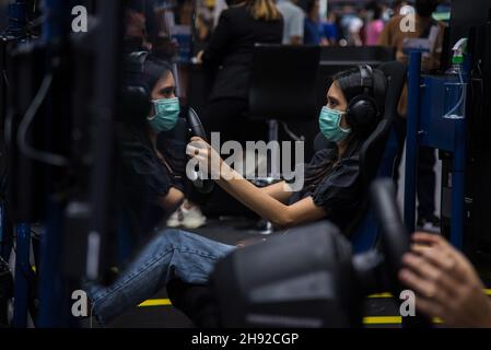 Nonthaburi, Thaïlande.03ème décembre 2021.Un visiteur a vu jouer un simulateur de course à Motor Expo.The 38e Thailand International Motor Expo 2021 qui a eu lieu du 1er décembre 2021 au 12 décembre,2021 présenter 32 marques automobiles et 12 marques de motos ainsi que des véhicules électriques pour stimuler les ventes globales et ramener l'industrie automobile sur le marché après le ralentissement économique causé par la pandémie prolongée de COVID-19.Crédit : SOPA Images Limited/Alamy Live News Banque D'Images