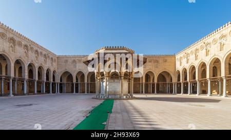 Fontaine d'ablution servant de support à la cour de la mosquée historique publique du Sultan al Muayyad, avec arrière-plan de couloirs voûtés entourant la cour, le Caire, Égypte Banque D'Images