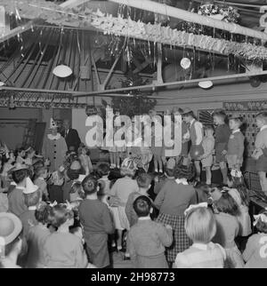 John Laing and son Limited, page Street, Mill Hill, Barnett, Londres,13/12/1958.Deux hommes, vêtus de clowns, divertis les enfants lors d'une fête de Noël pour enfants à Mill Hill. Banque D'Images