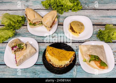 Vue de dessus de divers types de sandwichs et de wraps sur les assiettes Banque D'Images