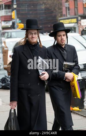 2 les juifs hassidiques reviennent de prières du matin et de quelques achats.Sur Lee Avenue à Williamsburg, Brooklyn, New York. Banque D'Images