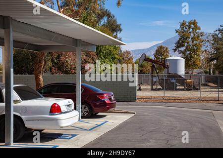 Puits de pétrole à côté du port de voiture dans le complexe d'appartements, Arvin, Kern County, Californie Banque D'Images