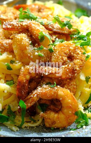 Fettuccine italienne alfredo avec crevettes cajun servi avec du vin blanc de pinot grigio Banque D'Images