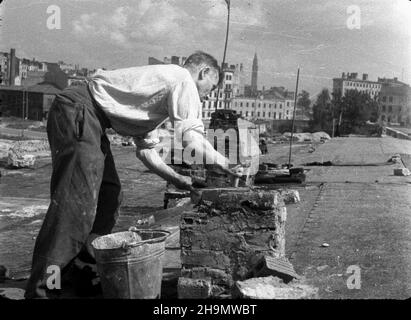 Varsovie, 1948-10.W odbudowie miasta po zniszczeniach wojennych bior¹ udzia³ mieszkañcy.NZ. Naprawa kominów W zniszczonym domu W Œródmieœciu.W g³êbi koœció³ pw.œw.Augustyna na terenie by³ego getta. pw PAP Dok³adny dzieñ wydarzenia nieustalony.Varsovie, octobre 1948.Les résidents de Varsovie participent à la reconstruction de la ville ravagé par la guerre.Photo : réparations de toit dans une maison en ruines dans le centre-ville.En arrière-plan l'église St Augustine dans l'ancien ghetto. pw PAP Banque D'Images