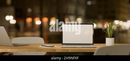 Table de travail portable dans un espace de travail commun la nuit avec maquette d'écran vierge pour ordinateur portable.3d rendu, 3d illustration Banque D'Images