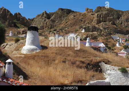 Maisons troglodytes à Guadix, maisons troglodytes blanches avec cheminées dans le quartier troglodyte de Guadix, cheminées dans la terre, maisons sur la montagne, tuf calcaire Banque D'Images