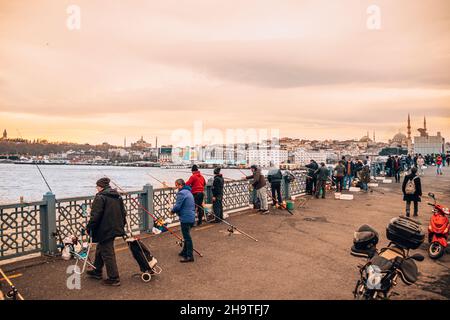 Les gens pêchent sur un pont avant le paysage d'Istanbul.Cannes à pêche et vue sur la mosquée. Banque D'Images
