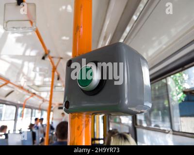 Bouton d'arrêt en tram urbain.Demande d'ouverture de porte par bouton dans les transports en commun.Gros plan Banque D'Images