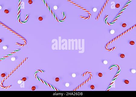 Cannes de Noël formant un cadre autour de fond violet avec espace de copie Banque D'Images