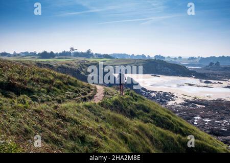 Saint-Briac-sur-Mer (sud-est de la France) : sentier côtier le long du parcours de golf de Dinard et de la falaise menant à la plage de Port Hue.Homme, randonneur avec un ba Banque D'Images