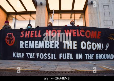 Londres, Royaume-Uni.10th décembre 2021.Les manifestants tiennent une bannière « Hell Not Welcome » faisant référence aux neuf Ogoni, un groupe de neuf activistes nigérians anti-Shell exécutés en 1995.Les manifestants se sont rassemblés devant le siège social de Shell au Royaume-Uni, alors que les actionnaires de la société ont voté pour le déménagement de leur siège social international des pays-Bas vers le Royaume-Uni. Banque D'Images