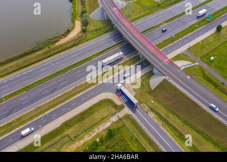 Antenne logistique du chariot. Les camions se mettent en mouvement par la route d'intersection entre les champs. Vue de drone. Banque D'Images