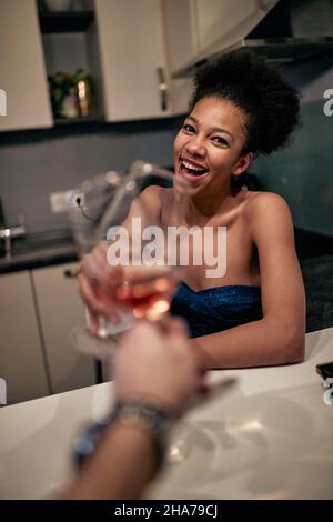 Une femme souriante toaste avec du vin célébrant Banque D'Images